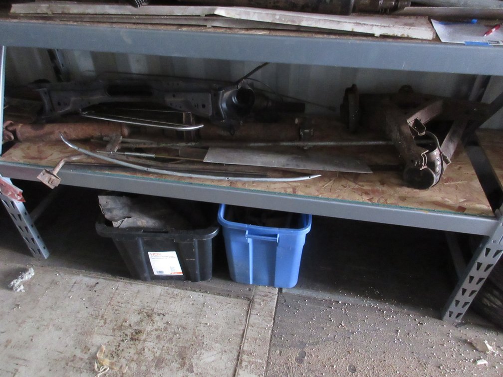 Group of auto parts on shelf and floor