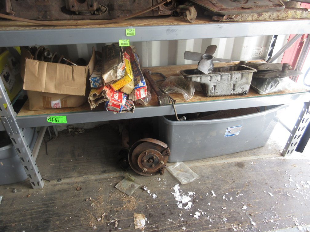 Group of auto parts on shelf and floor