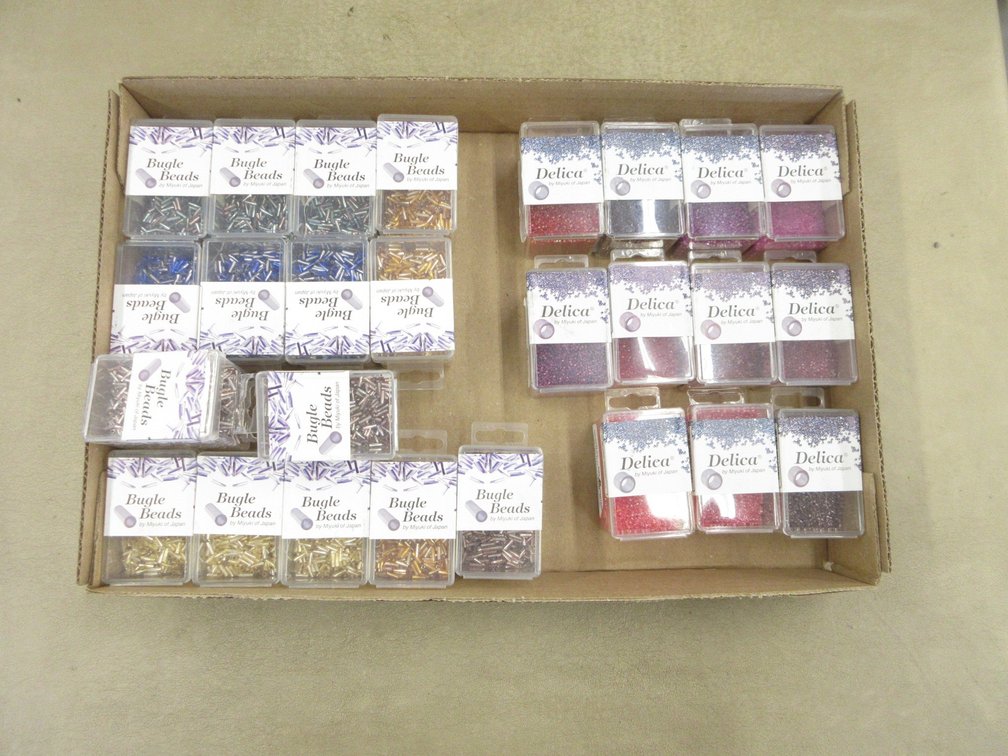 Box of packages of beads for jewelry-making, all sealed