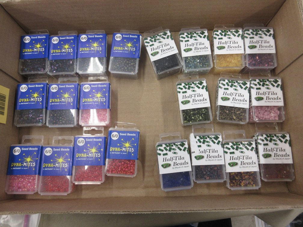 Box of Half-Tila beads and Dyna-Mites seed beads in packages