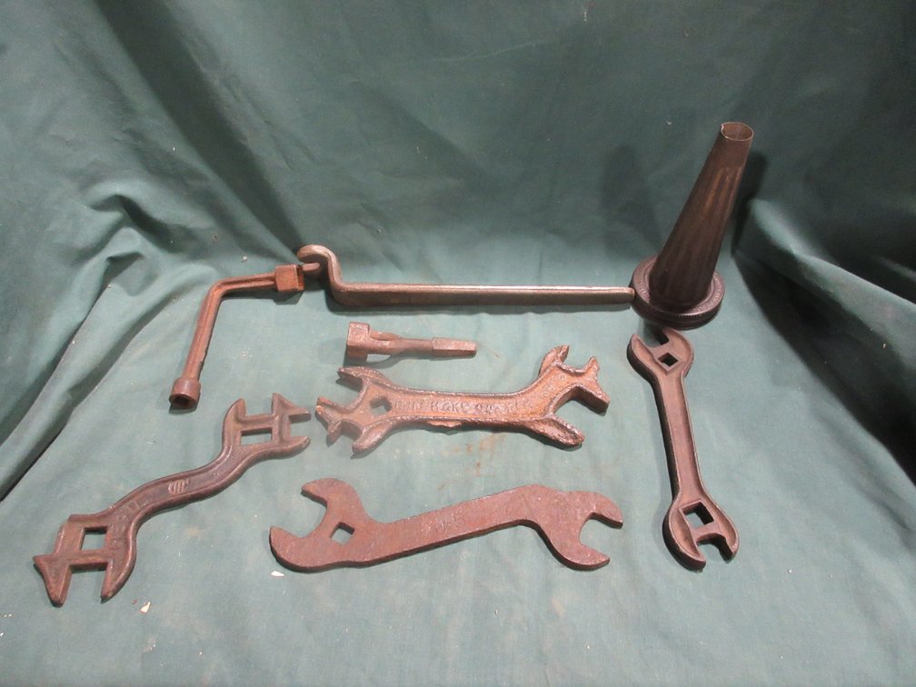 Group of antique wrenches and oil funnel