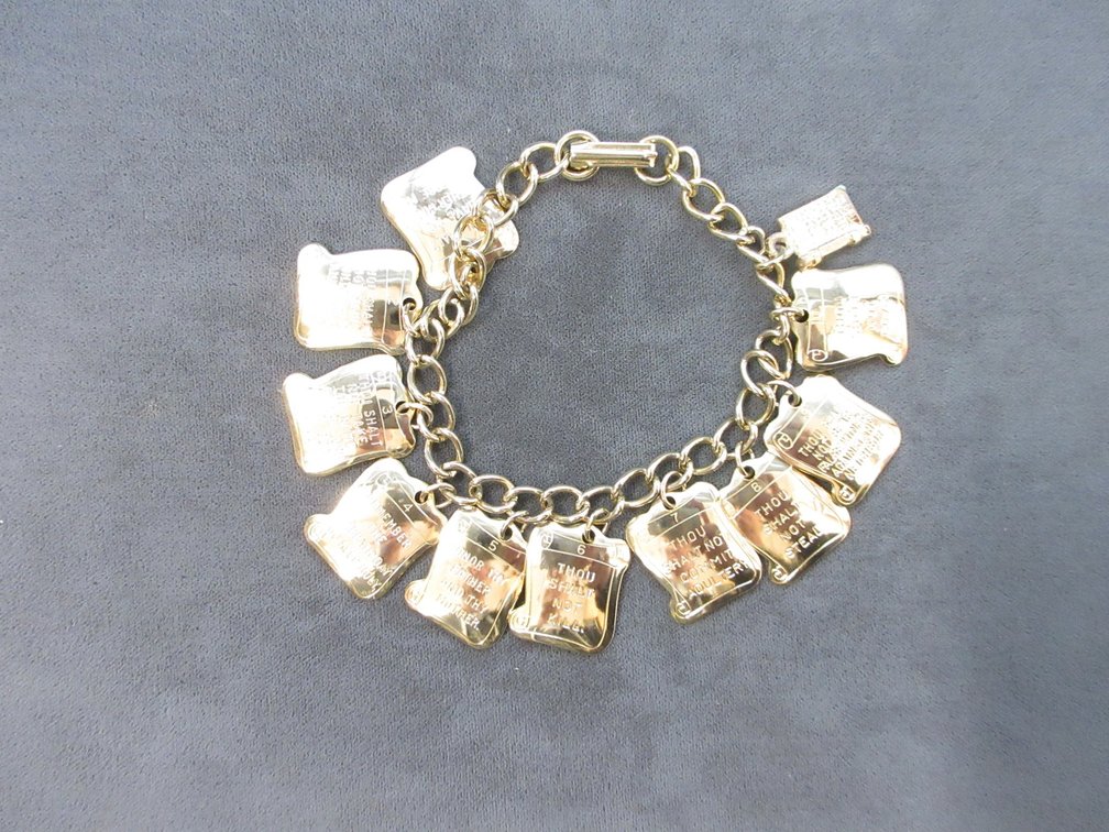 Gold tone charm bracelet with The Ten Commandment charms