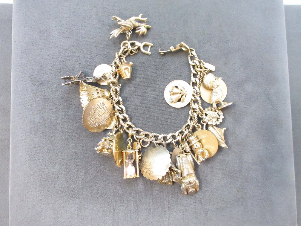 Monet charm bracelet with assorted charms including 14K and gold-filled