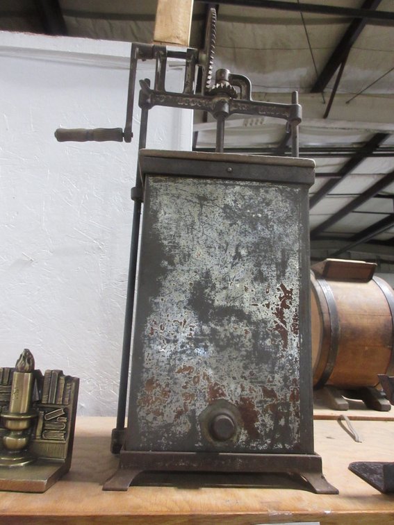 Antique tin hand-crank butter churn