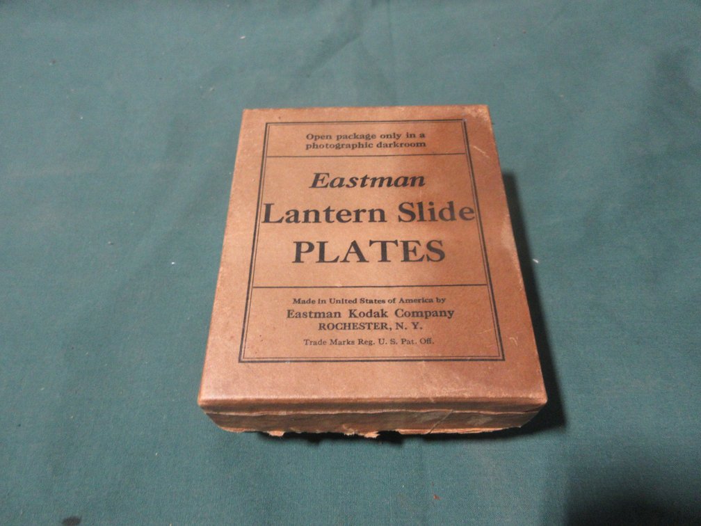 Group of antique glass photo pictures in box