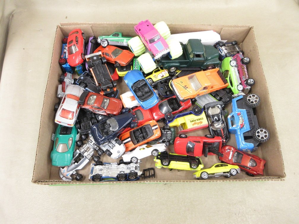 Box of die cast cars, trucks, and more