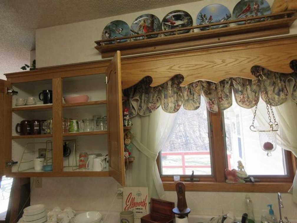 Group above sink and in far left cabinet