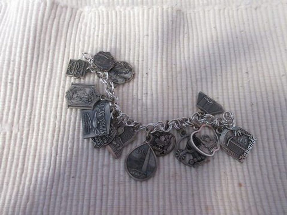 Silver tone bracelet with sterling charms
