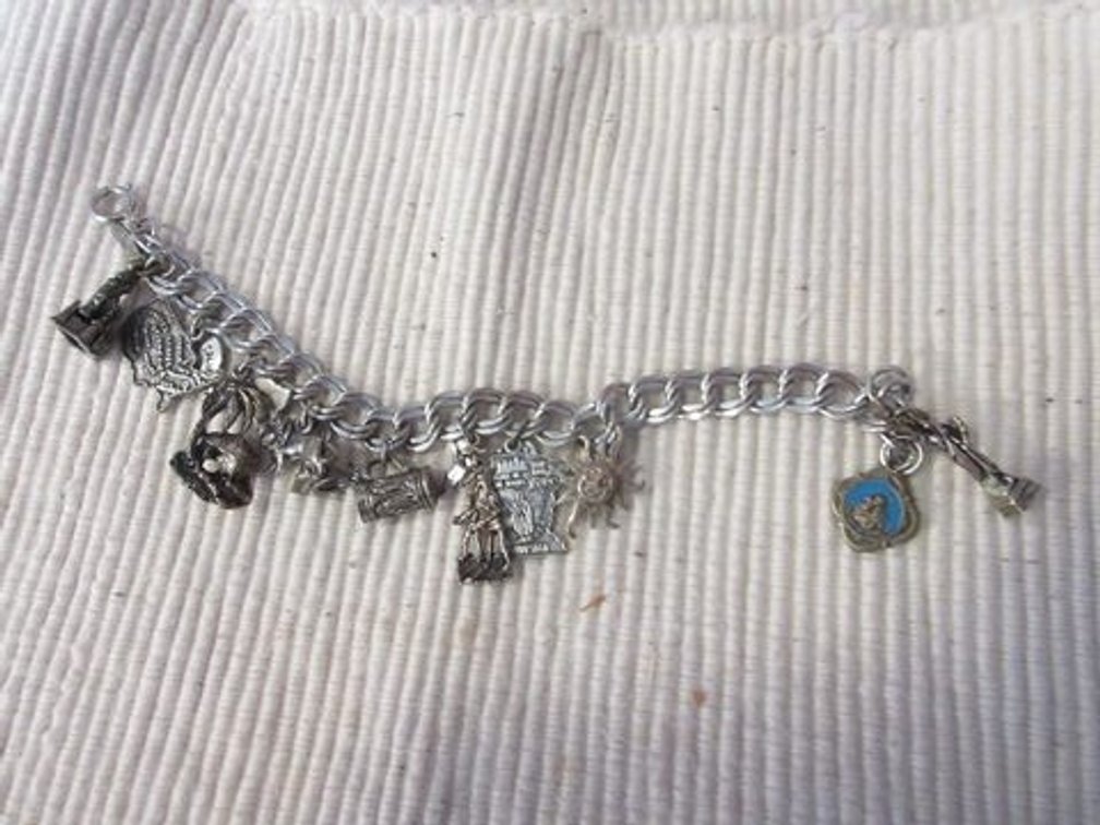 Silver tone bracelet with sterling charms