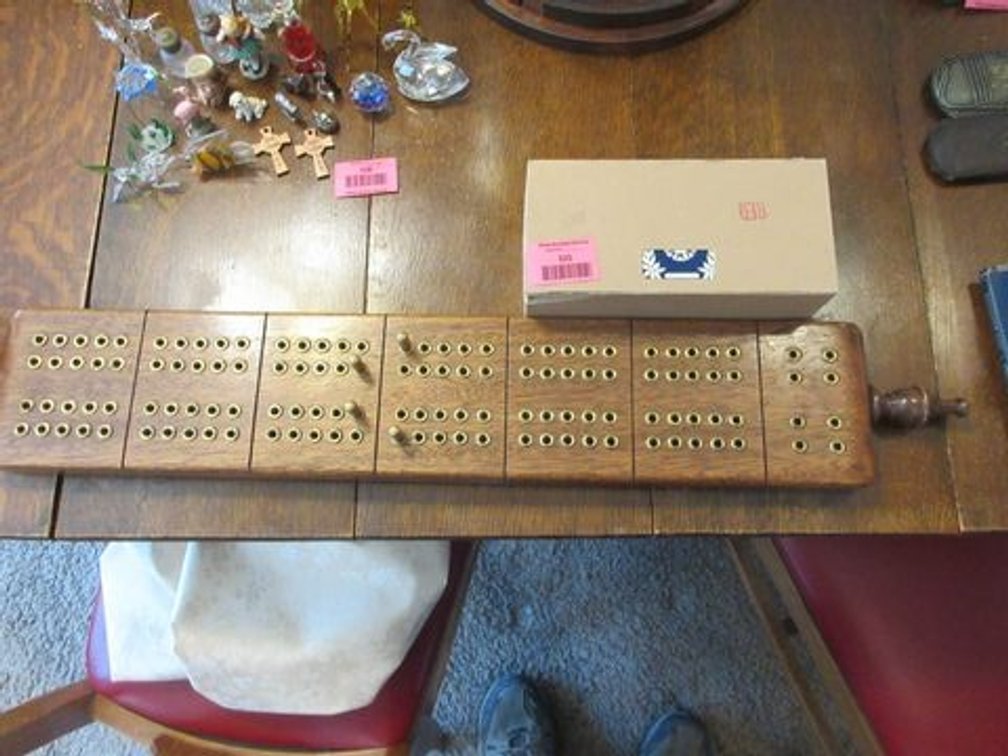 Wood cribbage board with brass pins