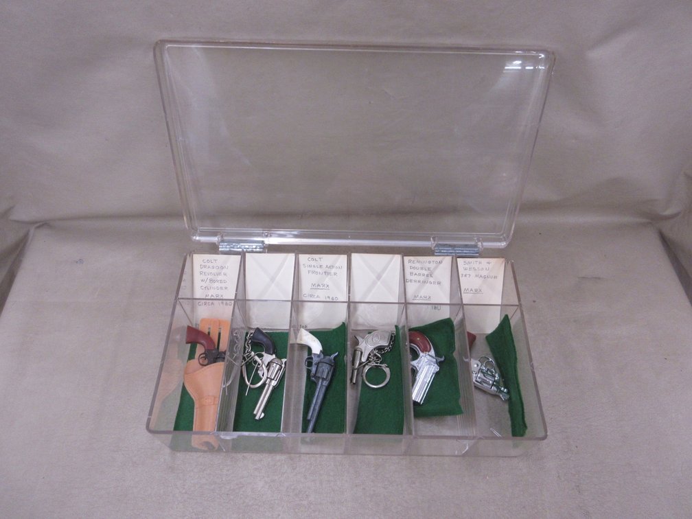 Plastic case with (6) Marx toy pistols