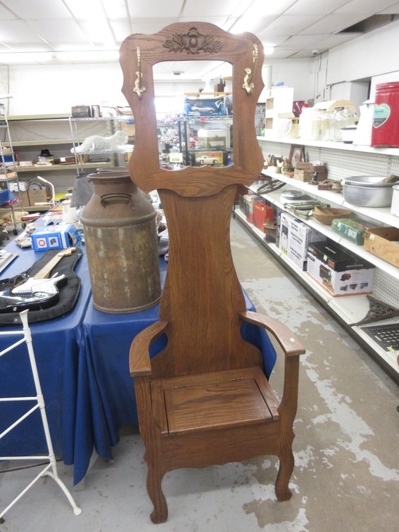 Wooden hall tree chair with applied carving, coat hooks and mirror insert