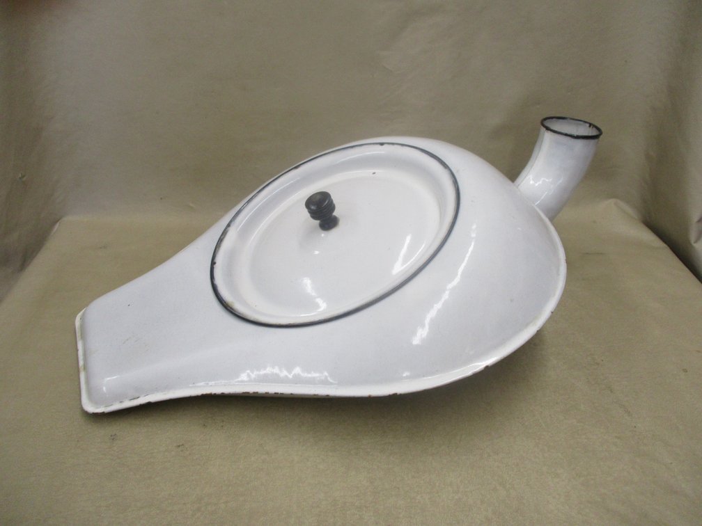 White enamelware bedpan with cover