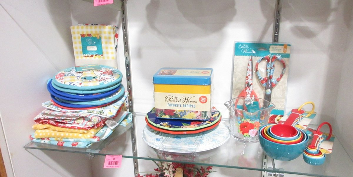 Shelf of Pioneer Woman kitchen items