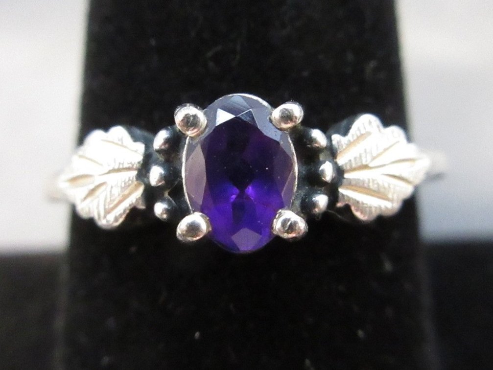 Sterling silver ring with dark purple stone in leaf design