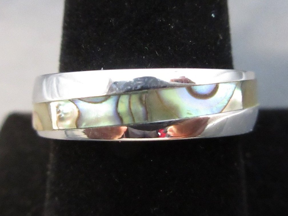 Unmarked silver colored band with abalone inset