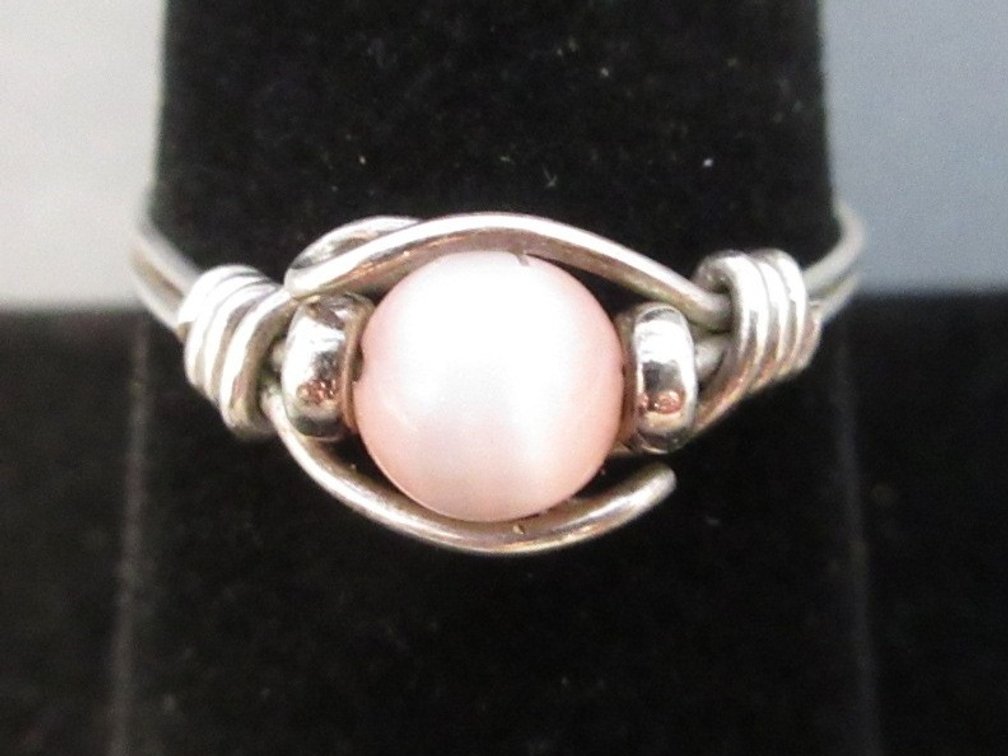 Unmarked silver color wire ring with pink tiger eye stone