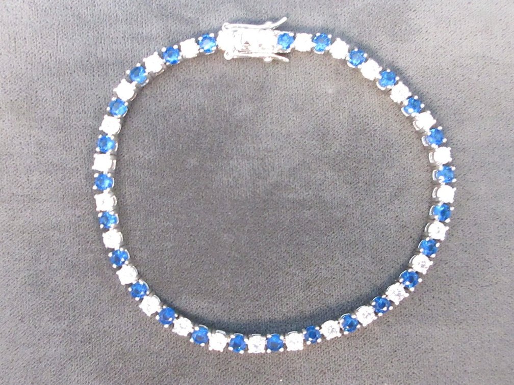 Unmarked silver color bracelet with blue and clear stones