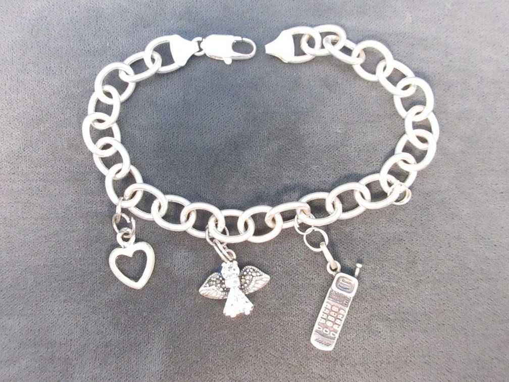 Marked .925 Italy charm bracelet with (3) charms including .925 angel and .925 phone