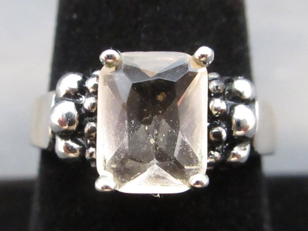 Unmarked silver color ring with off-white princess cut stone