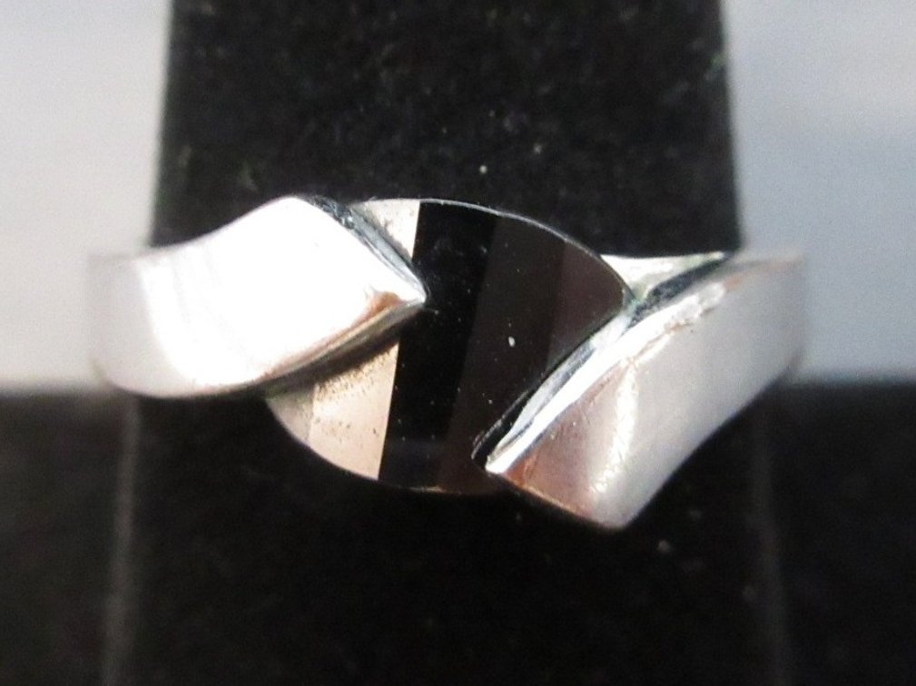 Unmarked silver color ring with black stone