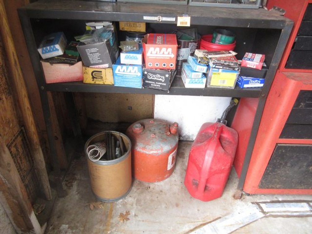 Metal stand with contents of shelf and on floor