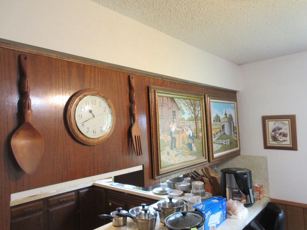Group of decor on side and back of upper cabinets