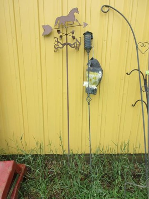Tiki torch with plastic owl and weathervane