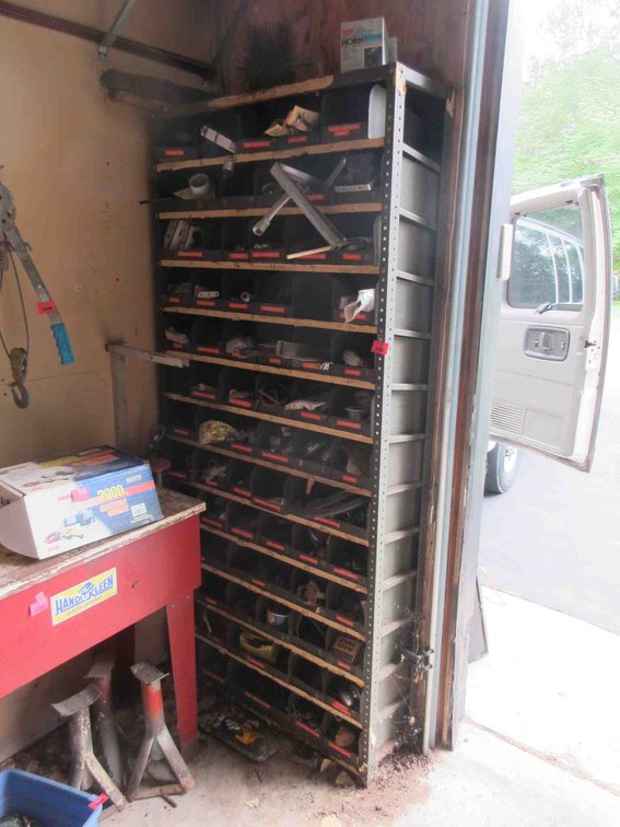 Metal shelf with hardware bins and hardware