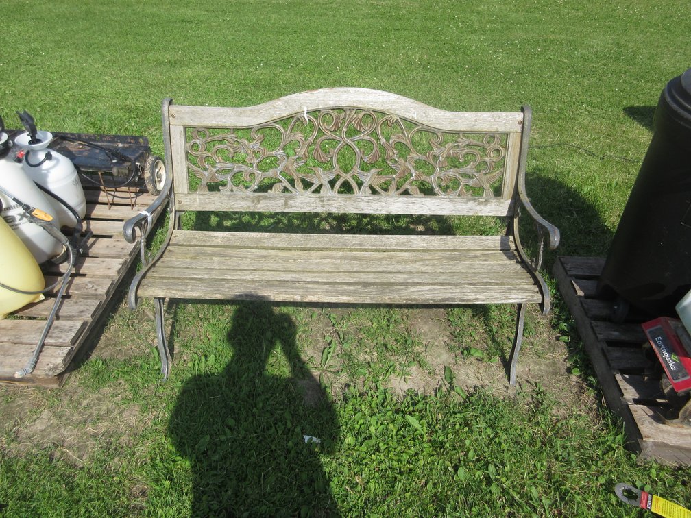 Cast metal bench with wood seat