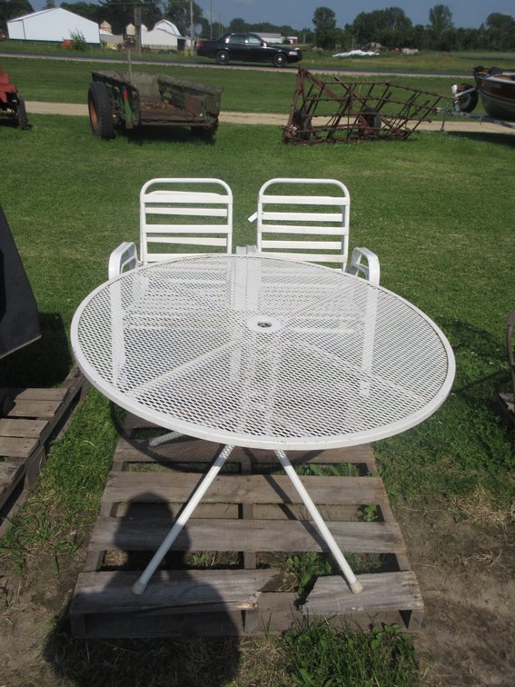 White wrought iron round patio table with (4) matching chairs