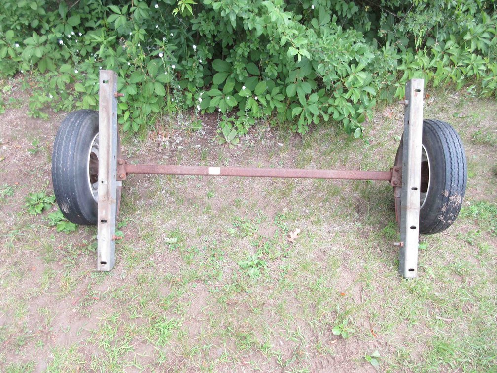 Trailer axle with tires