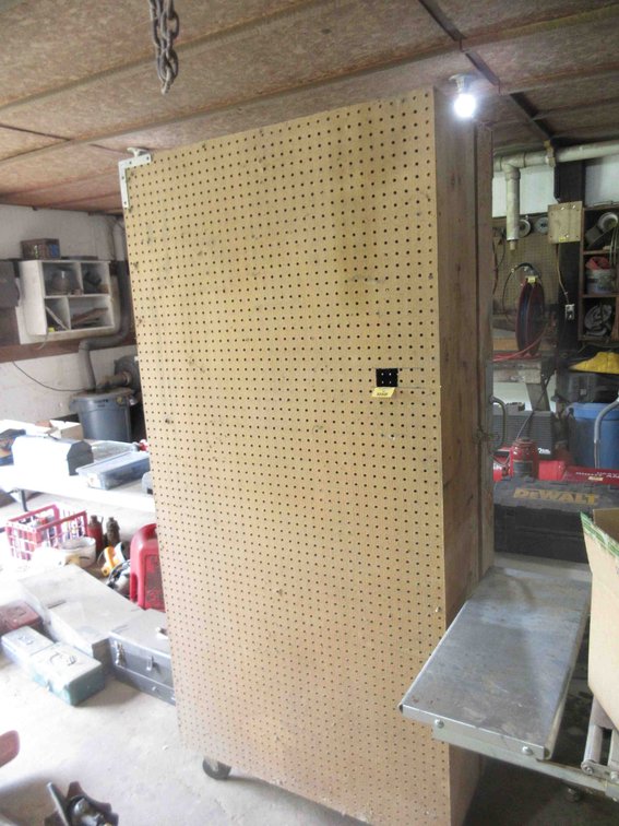 Rolling wood pegboard shop cabinet