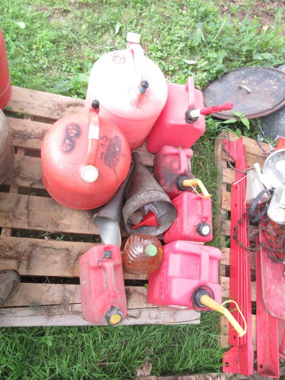 Group of plastic fuel cans and funnel
