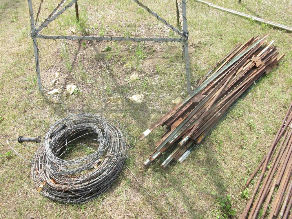 Group of T-posts and barbed wire