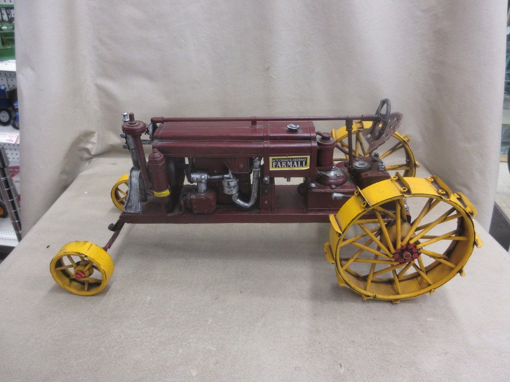 Pressed Steel McCormick Deering toy tractor with steel wheels