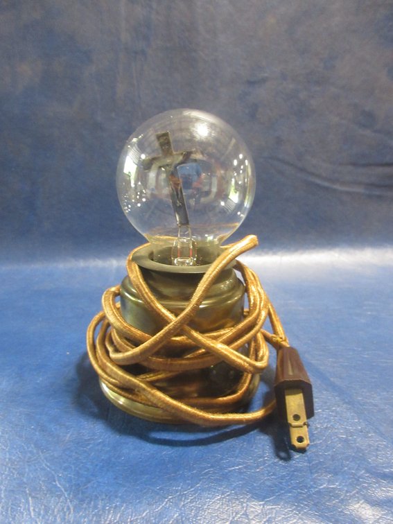 Vintage electric bulb with crucifix inside