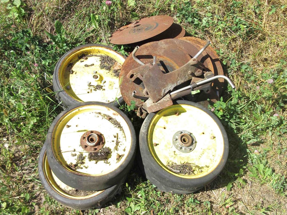 Group of John Deere planter wheels and parts