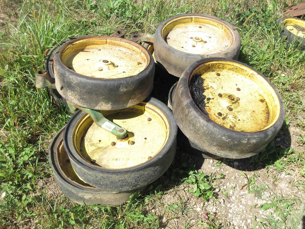 Group of John Deere planter wheels and parts