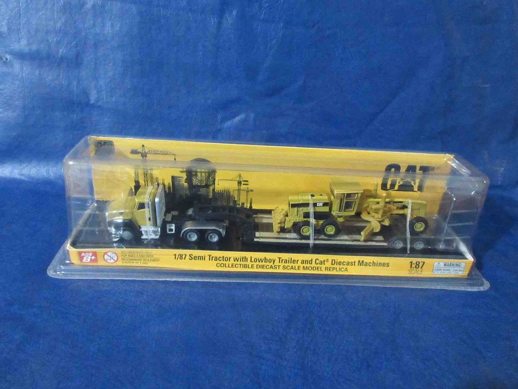Cat Semi-Tractor with lowboy trailer and Cat grader