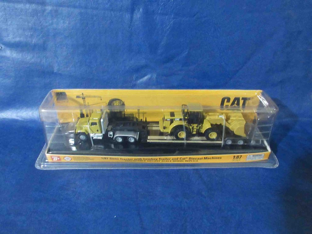 Cat Semi-Tractor with lowboy trailer and Cat wheel loader