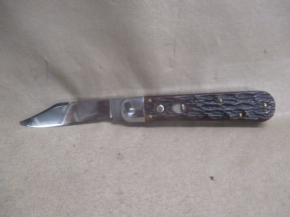 Sharpleigh folding knife with safety and button