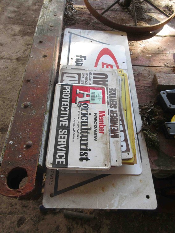 Group of metal and plastic farm signs