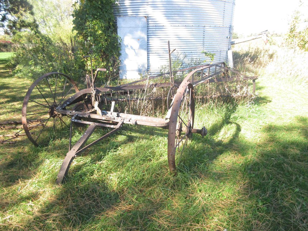 Antique dump rake with steel wheels