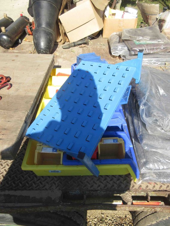 Group of plastic hardware bins with metal rack