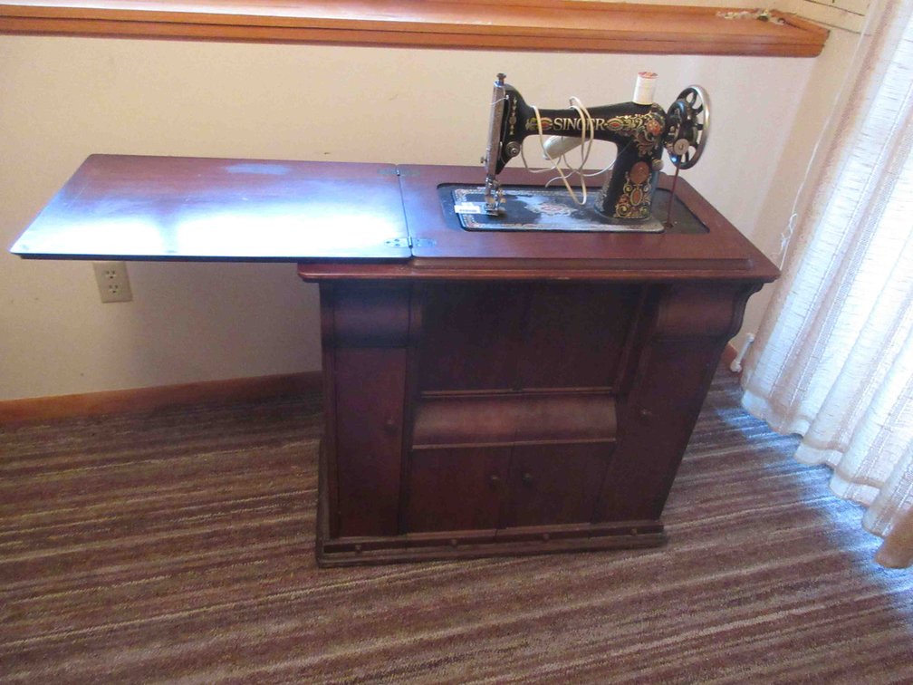 Singer treadle sewing machine in decorative wood cabinet