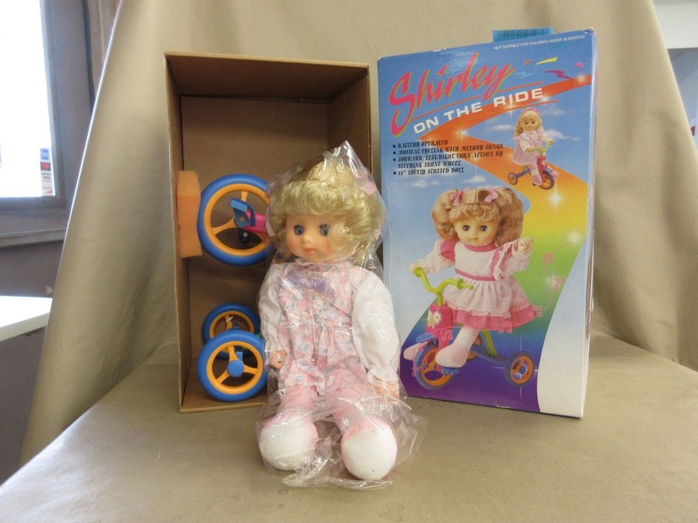 Battery-operated "Shirley On The Ride" doll