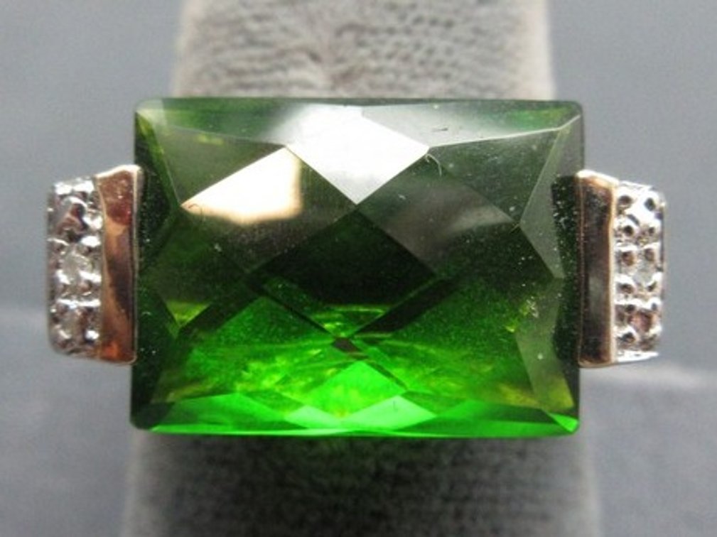 Marked .925 gold tone ring with large emerald green-colored stone