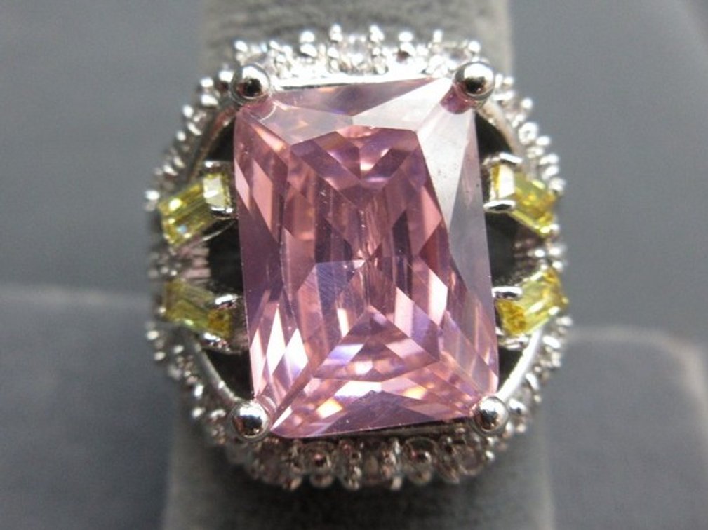 Marked .925 silver cocktail ring with large pink stone