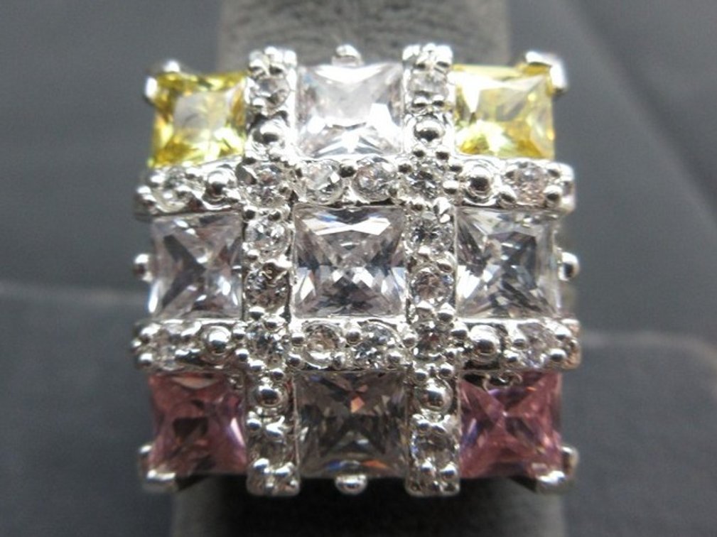Marked .925 silver cocktail ring with (9) stones